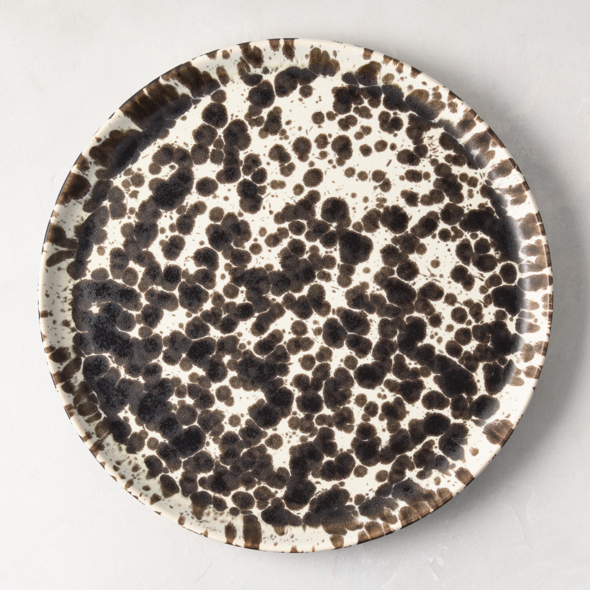 Nuno Splatter 11" stoneware dinner plate with unique brown spots on a pale cream base.