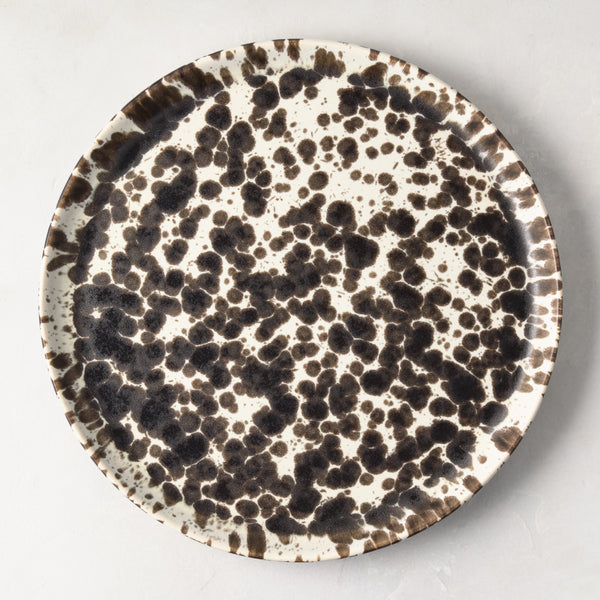 Nuno Splatter 11" stoneware dinner plate with unique brown spots on a pale cream base.