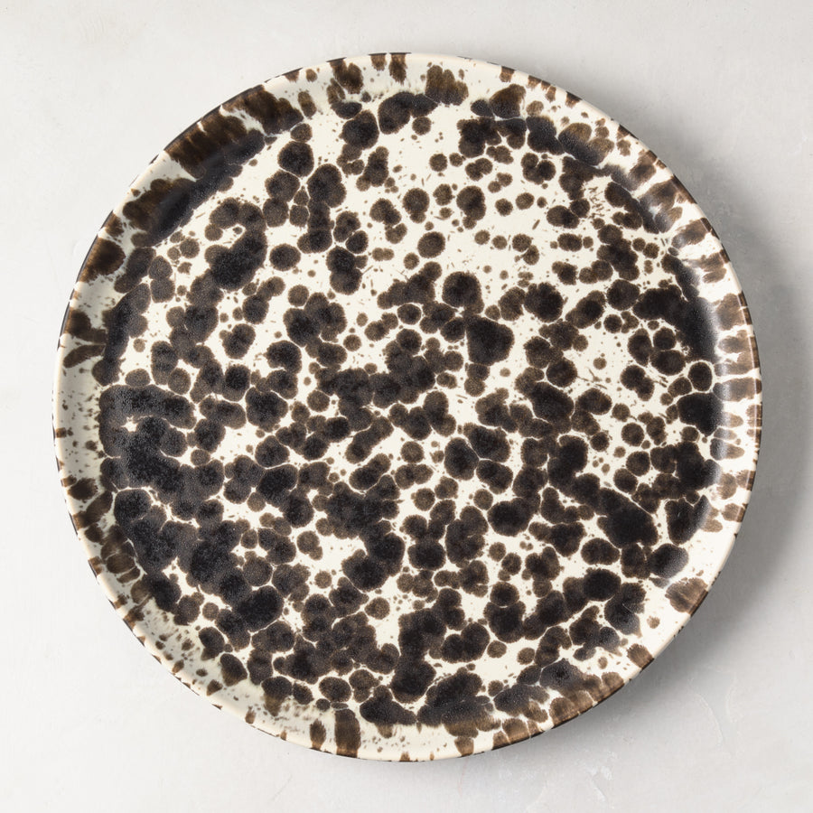 Nuno Splatter 11" stoneware dinner plate with unique brown spots on a pale cream base.