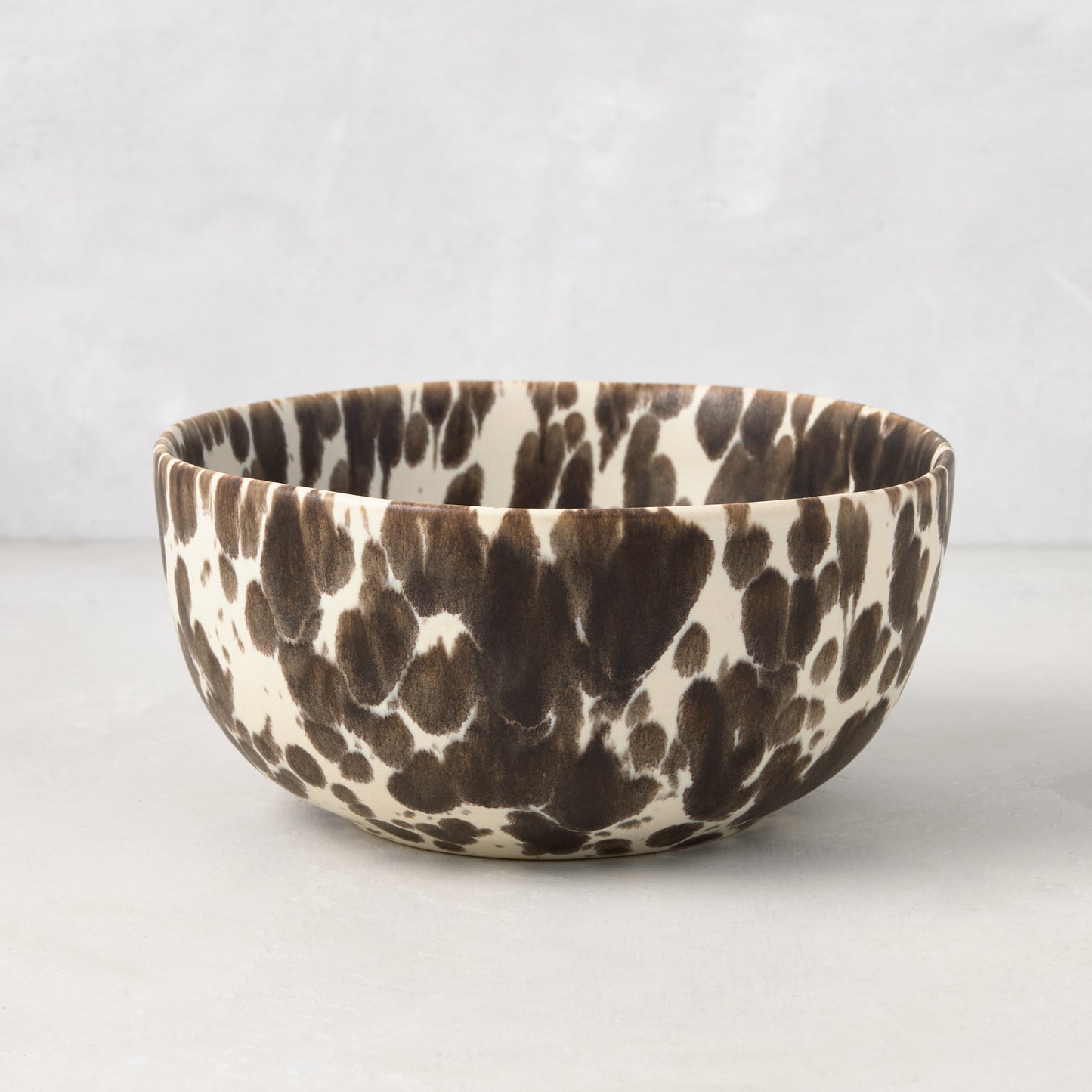 Nuno Splatter Stoneware Individual Bowl, 6"Dia, with brown splatter on a pale cream base.