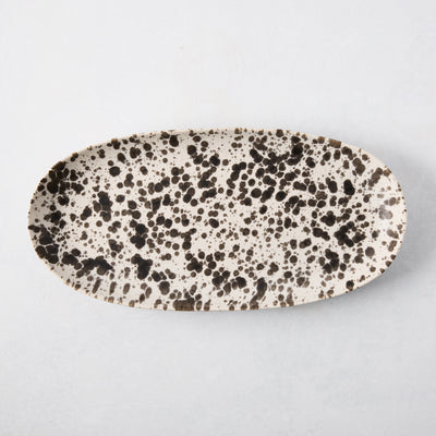 Nuno Splatter oval stoneware serving platter, pale cream with unique brown splatter design.
