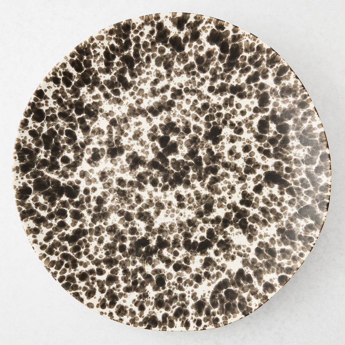 Nuno Splatter Stoneware Round Serve Platter, 15.55"Dia, with brown splatter on a pale cream base.