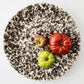 Nuno Splatter Stoneware Round Serve Platter, 15.55"Dia, with brown splatter on cream base.