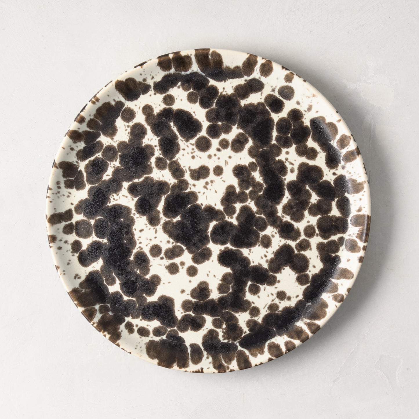 Nuno Splatter 8.2"Dia stoneware salad plate with unique brown splatter on a pale cream base.