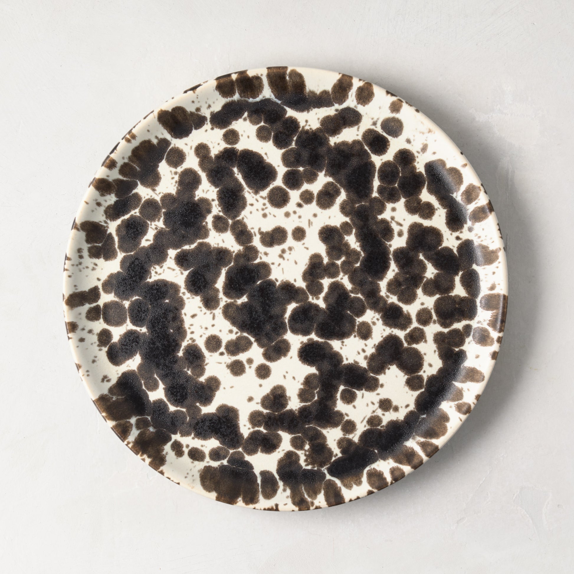 Nuno Splatter 8.2"Dia stoneware salad plate with unique brown splatter on a pale cream base.