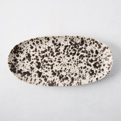 Nuno Splatter oval stoneware serving platter, pale cream with unique brown splatter design.