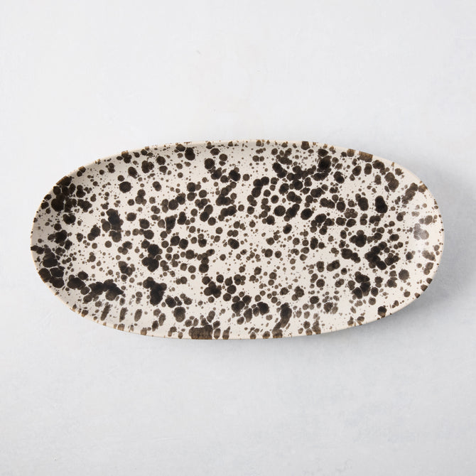 Nuno Splatter oval stoneware serving platter, pale cream with unique brown splatter design.