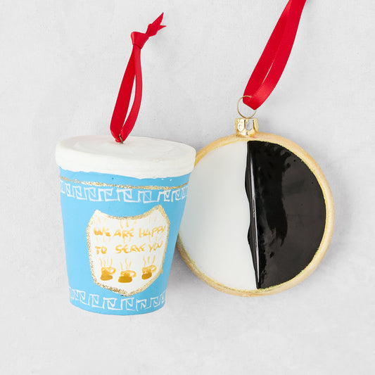 NYC deli cup and black and white cookie Christmas ornaments with red ribbon hangers on a white background.