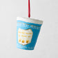 Hand-painted blue and white NYC deli cup Christmas ornament with "We Are Happy To Serve You" in gold glitter.