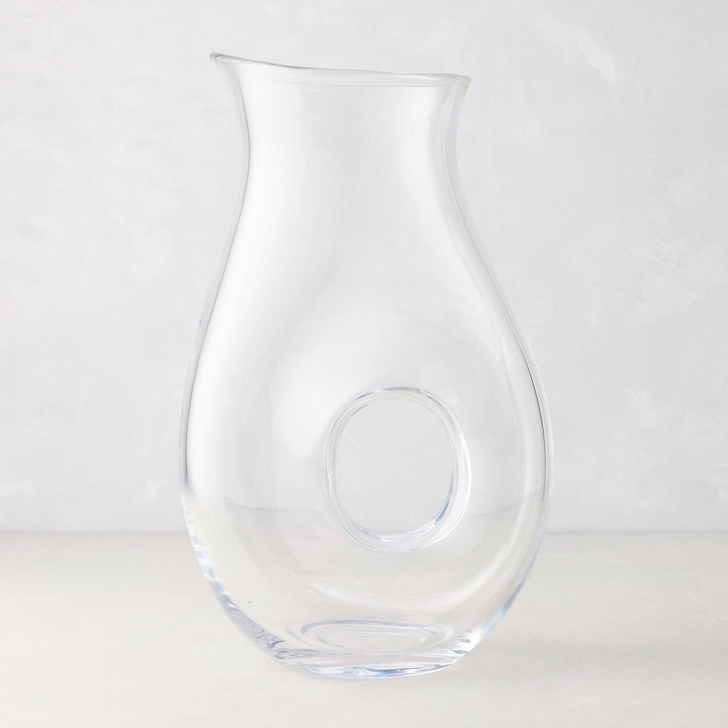 Clear glass "O" pitcher with an O-shaped interior handle, 10"H.