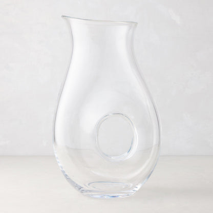 Clear glass "O" pitcher with an O-shaped interior handle, 10"H.