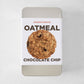 Silver rectangular tin with a white label featuring a single oatmeal chocolate chip cookie.