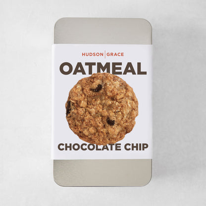 Silver rectangular tin with a white label featuring a single oatmeal chocolate chip cookie.