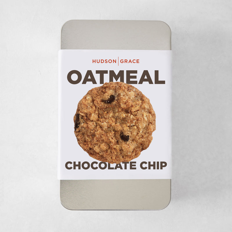 Silver rectangular tin with a white label featuring a single oatmeal chocolate chip cookie.