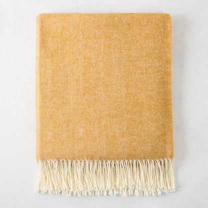 Ochre yellow Italian herringbone throw blanket with decorative fringe, 51"W x 67"L, cotton-acrylic blend.