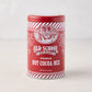Old School Premium Hot Cocoa Mix in a red cylindrical tin with white striped borders and vintage farm illustration.