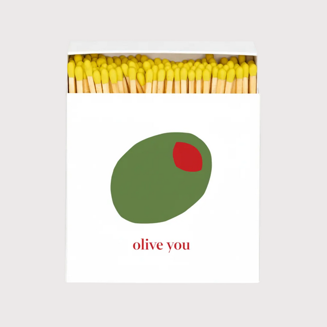 Olive You" oversized matches in a white box with a green olive and red pimento design, yellow match tips.