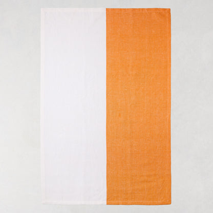 Orange and white block print cotton-linen hand towel, half orange, half white.