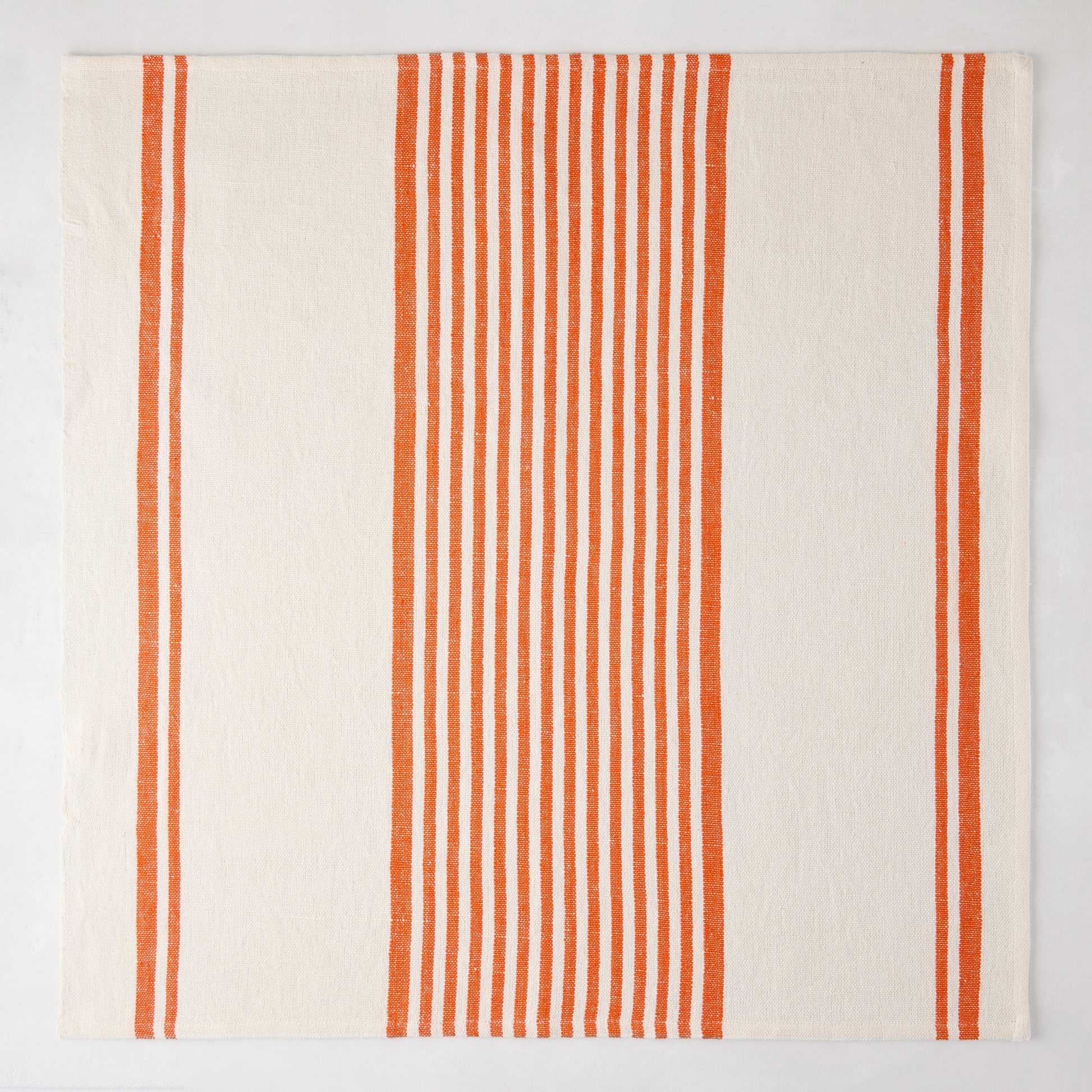 Orange Boat Stripe Napkin, 22" square, cotton-linen blend, with vertical orange stripes on cream.
