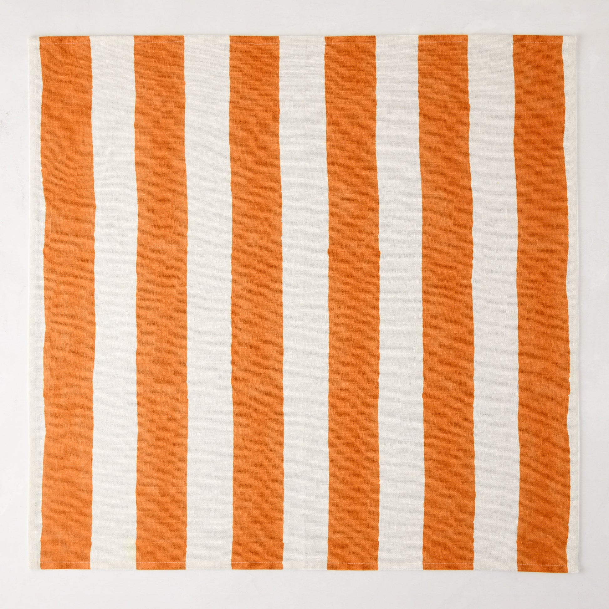 Orange Hampton Stripe Cotton Napkin, 22" square, with bold vertical orange and white stripes.