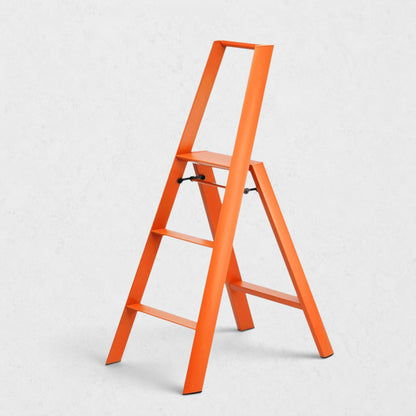 Hudson Grace orange Hasegawa Lucano 3-step ladder with a minimalist aluminum and steel design and non-skid feet.