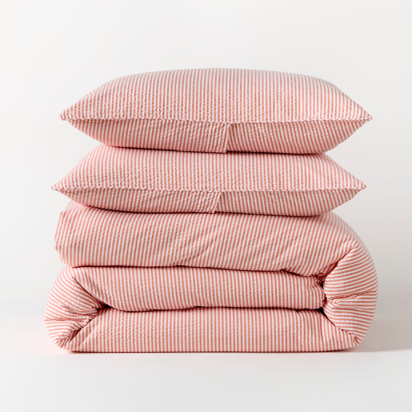 Stacked orange seersucker stripe organic cotton duvet and sham set.