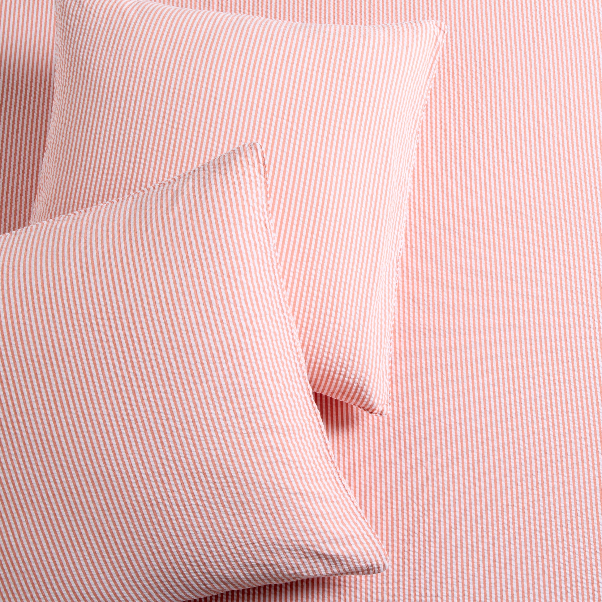 Set of 2 orange seersucker stripe organic cotton Euro shams with textured fabric.