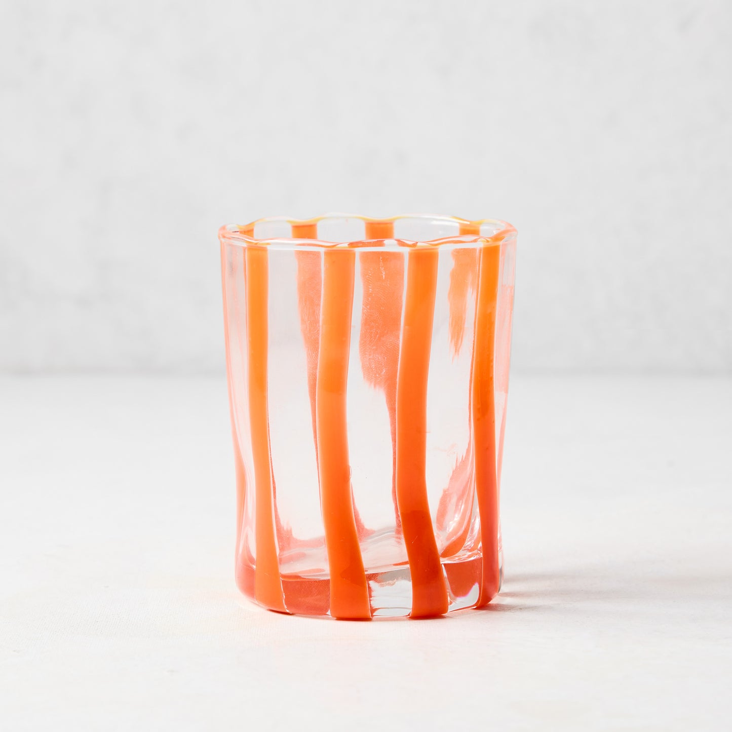Hand-made Italian glass Double Old Fashioned with vertical orange stripes.