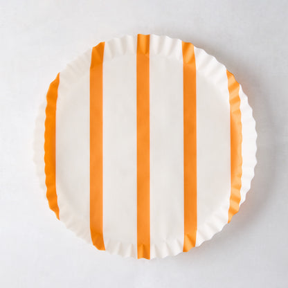 Round white parchment liner with vertical orange stripes and ruffled edges.