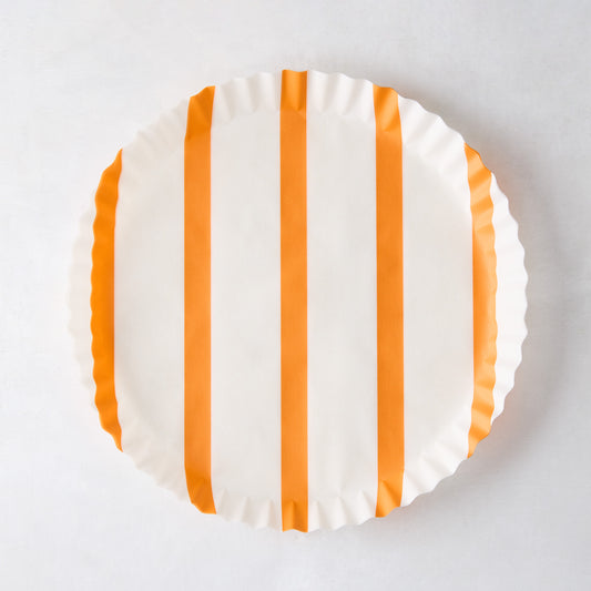 Round white parchment liner with vertical orange stripes and ruffled edges.