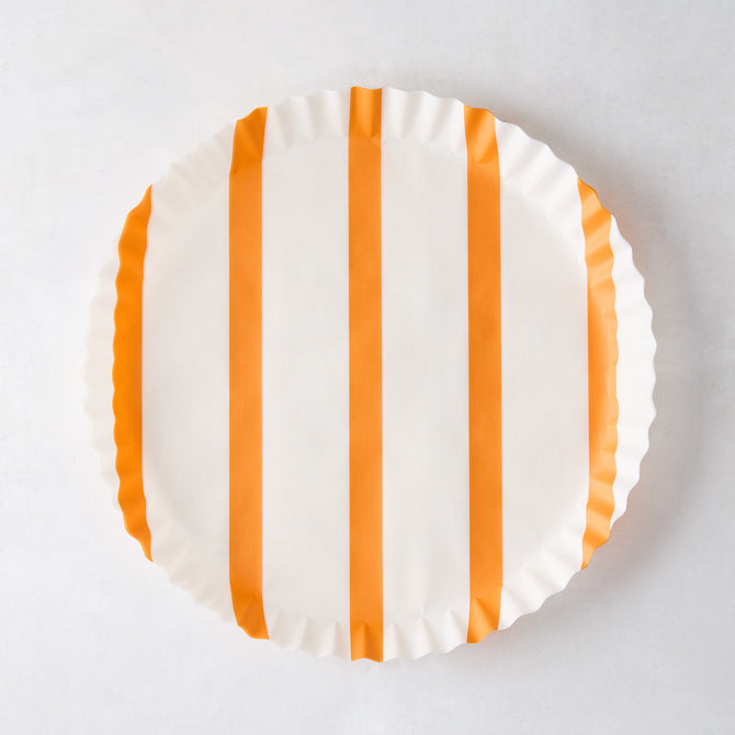 Round white parchment liner with vertical orange stripes and ruffled edges.