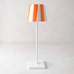 Hand-painted ceramic lamp shade with orange and white stripes on a white Poldina Pro lamp base.