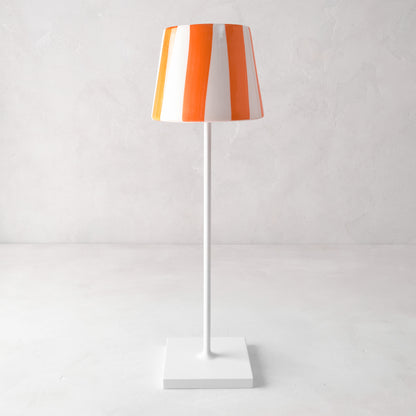 Hand-painted ceramic lamp shade with orange and white stripes on a white Poldina Pro lamp base.