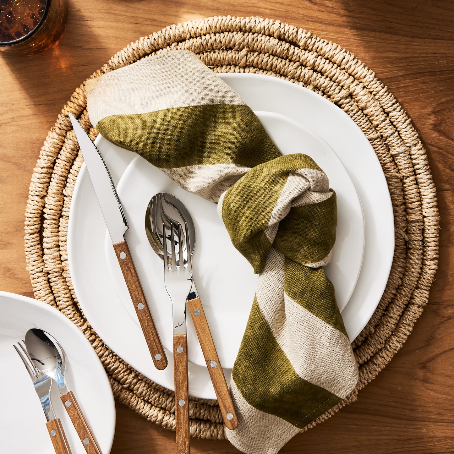 Organic Ceramic Dinner Plate, creamy white, 11.5" diameter, with subtle organic edges on a woven placemat.