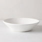 Organic Low Bowl, 9" creamy white ceramic with subtle organic edges.