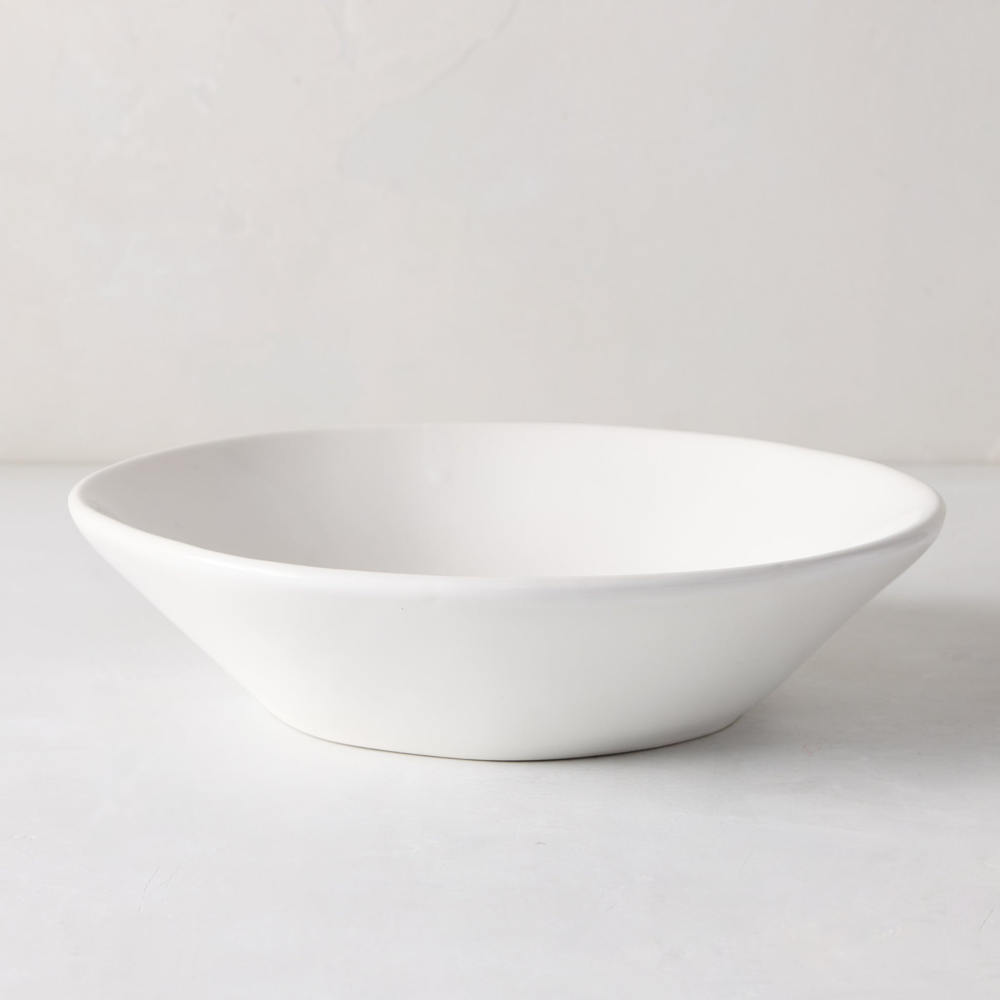 Organic Low Bowl, 9" creamy white ceramic with subtle organic edges.