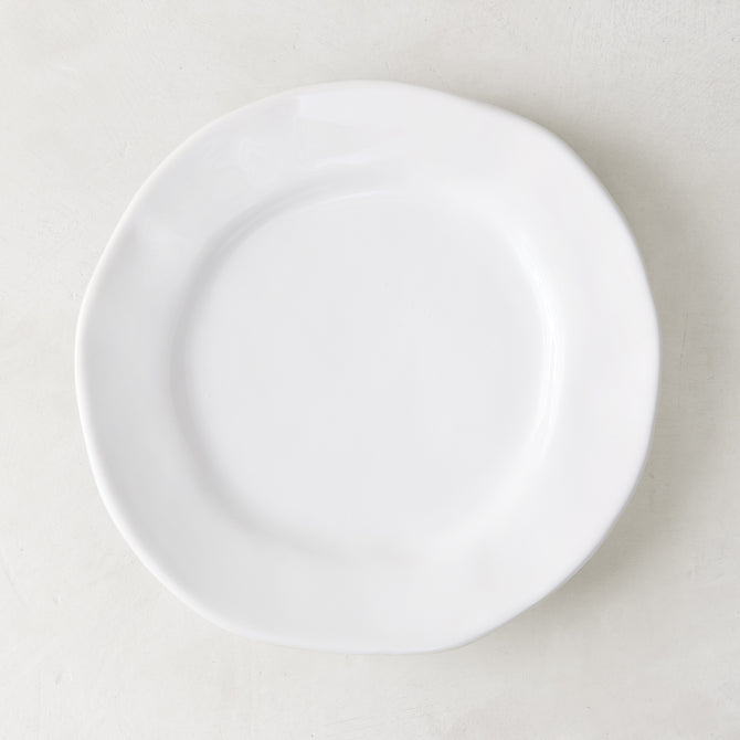 Creamy white ceramic salad plate with subtle organic edges, 9" diameter.