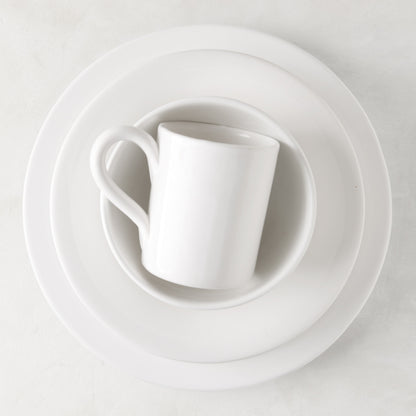 HG Original creamy white ceramic mug, 4" diameter, on stacked white plates.