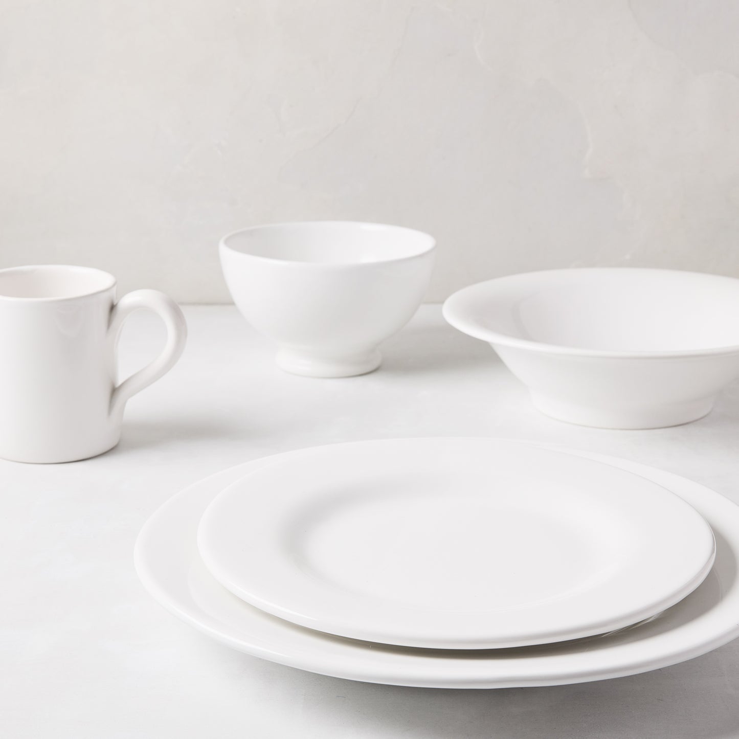 HG Original Collection creamy white ceramic salad plate, 10" diameter, with matching mug and bowls.