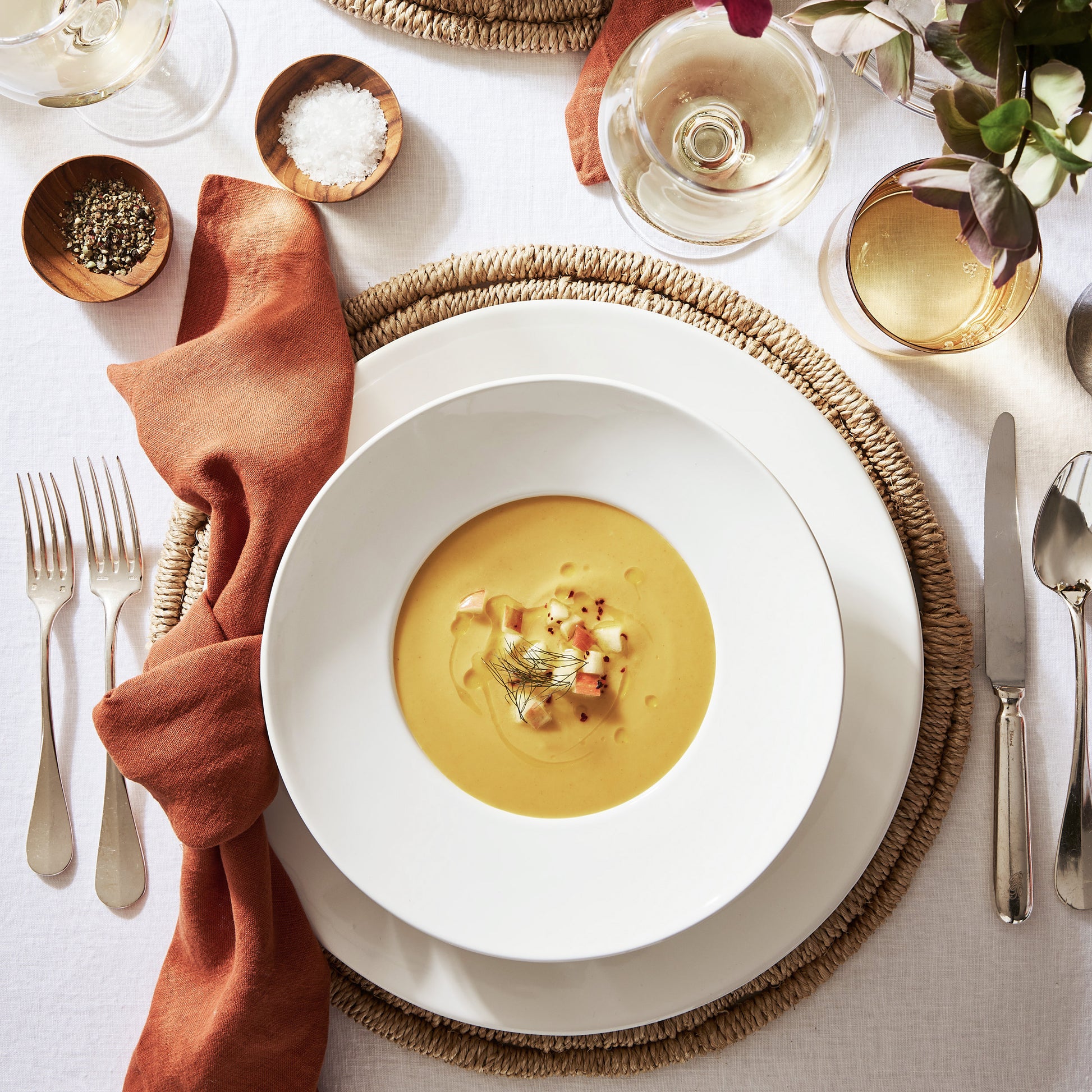 Oversized 12.5-inch creamy white ceramic dinner plate with a clean, minimalist design on a woven placemat.