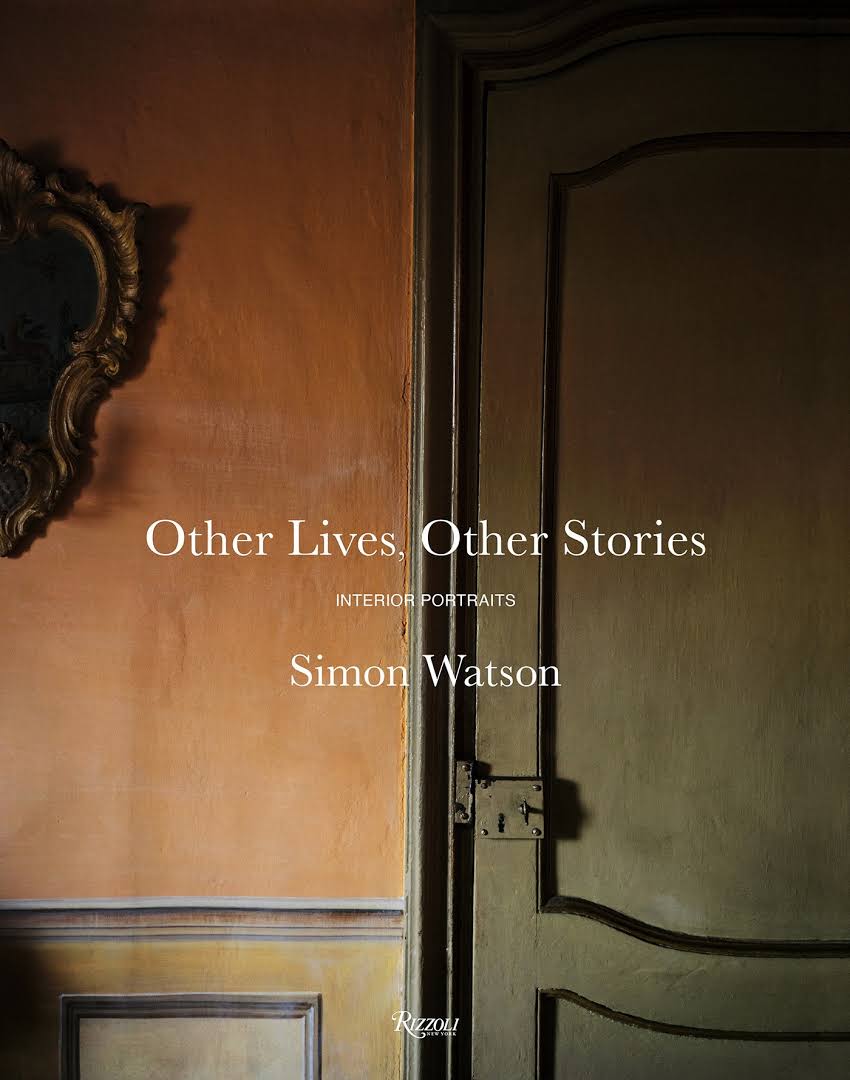 Hardcover book cover featuring an orange wall, arched wooden door, and ornate mirror frame in a rustic interior.