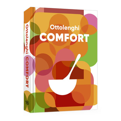 Hardcover cookbook, "Ottolenghi Comfort," with colorful abstract circles, white title, bowl, and spoon design.