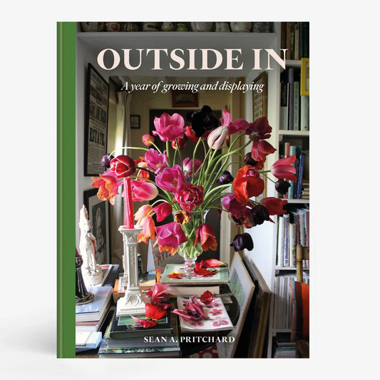 Hardcover book "Outside In" by Sean Pritchard with a green spine and a cover image of a vibrant floral arrangement.