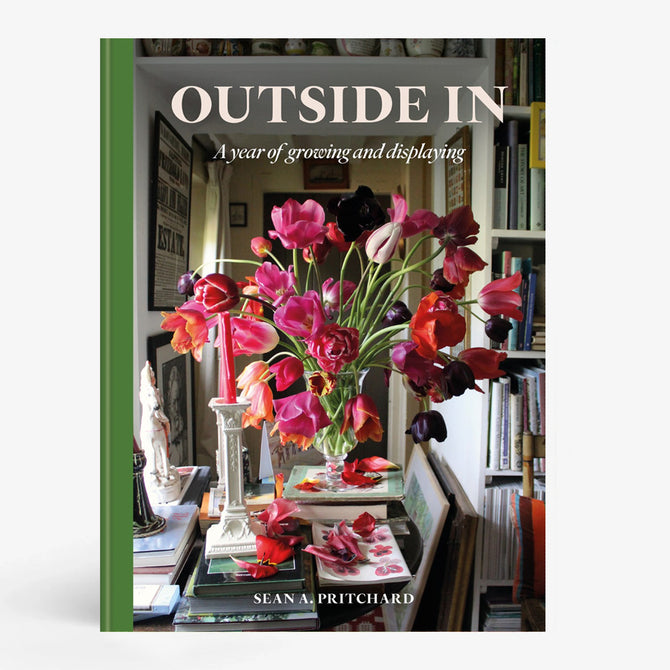 Hardcover book "Outside In" by Sean Pritchard with a green spine and a cover image of a vibrant floral arrangement.