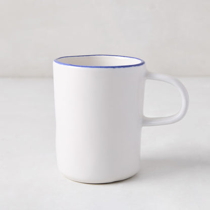 Pacific Blue-Rimmed Stoneware Mug, white with hand-painted blue edge, irregular shape.