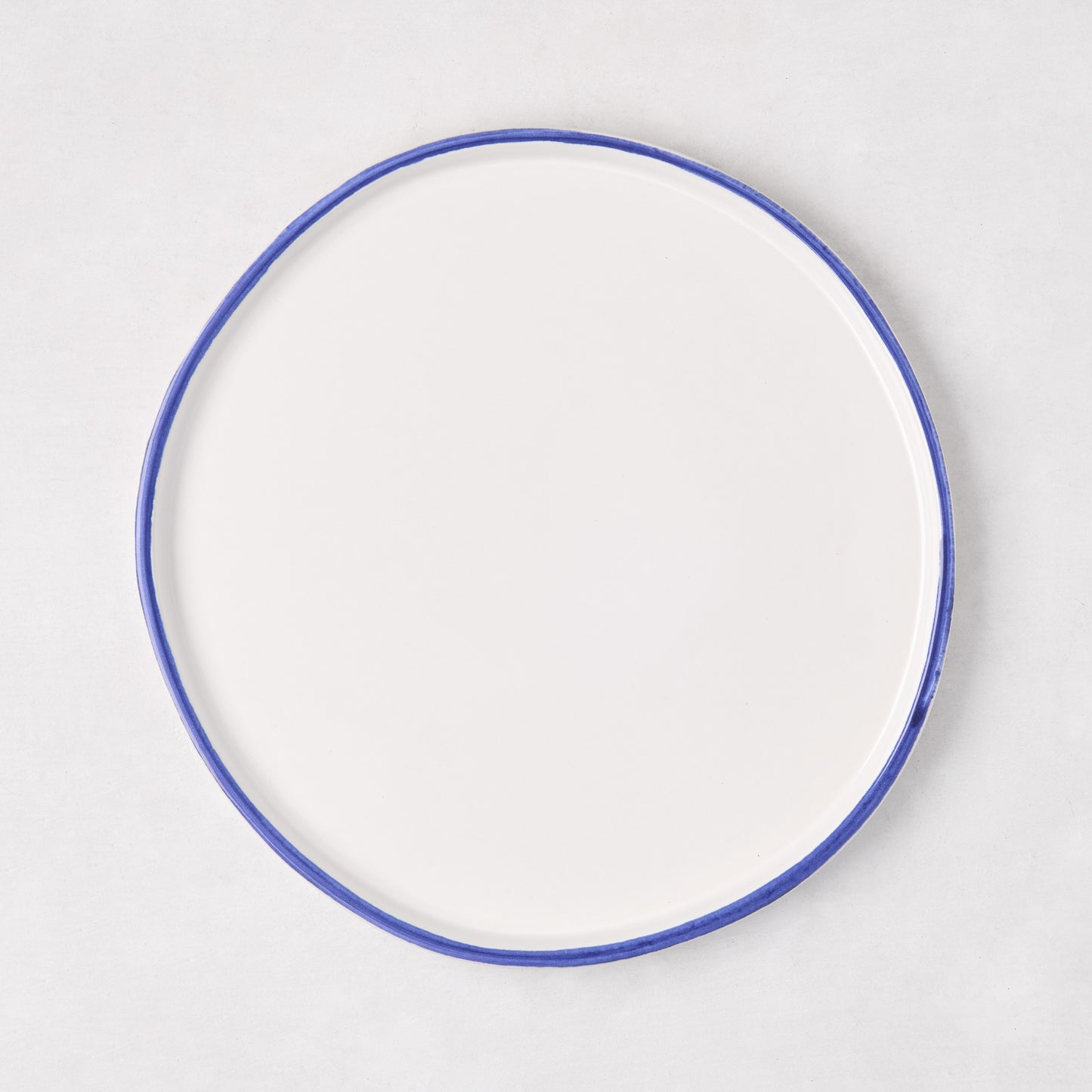 Pacific Blue-Rimmed Stoneware Salad Plate, 8" diameter, with hand-painted blue edge and irregular shape.