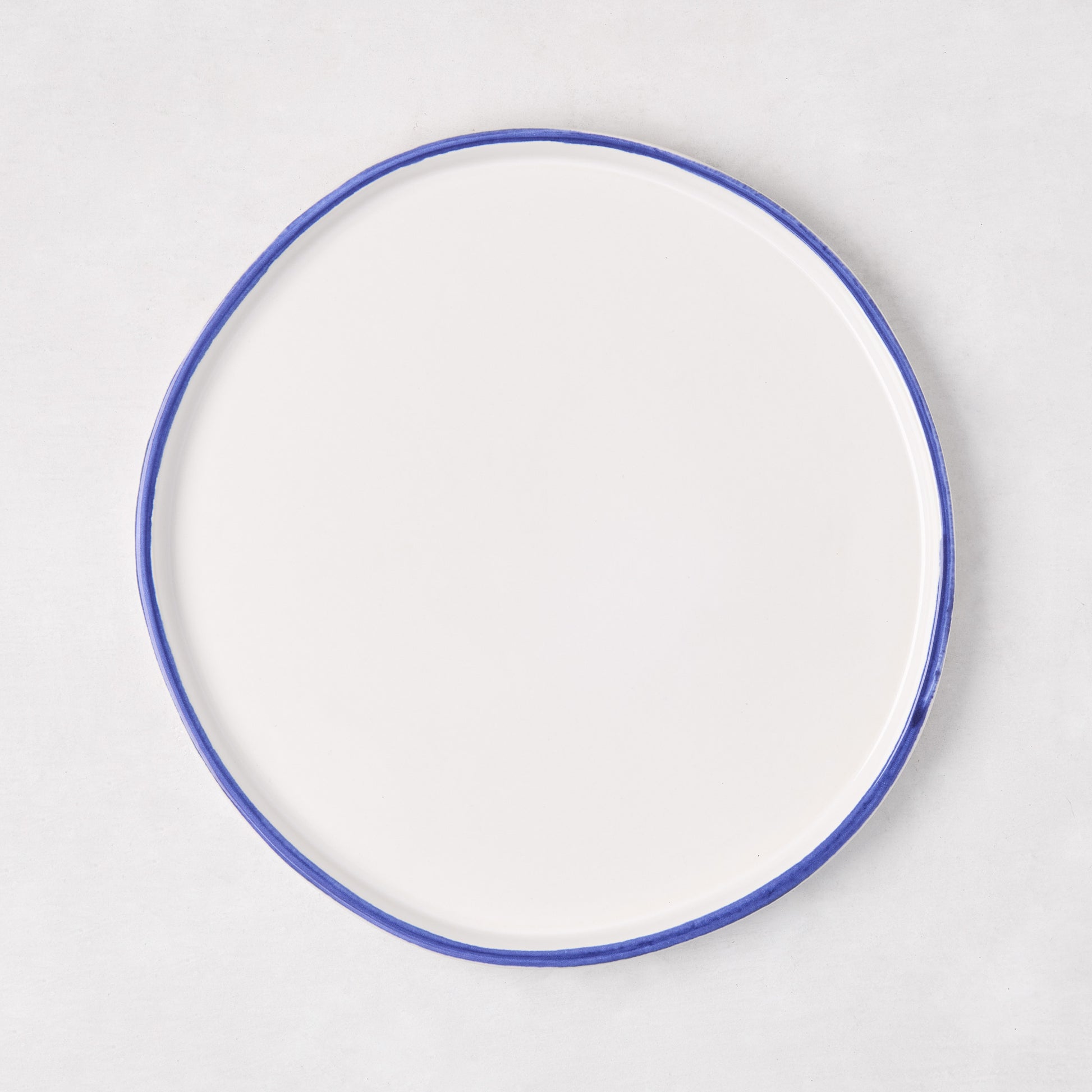 Pacific Blue-Rimmed Stoneware Salad Plate, 8" diameter, with hand-painted blue edge and irregular shape.