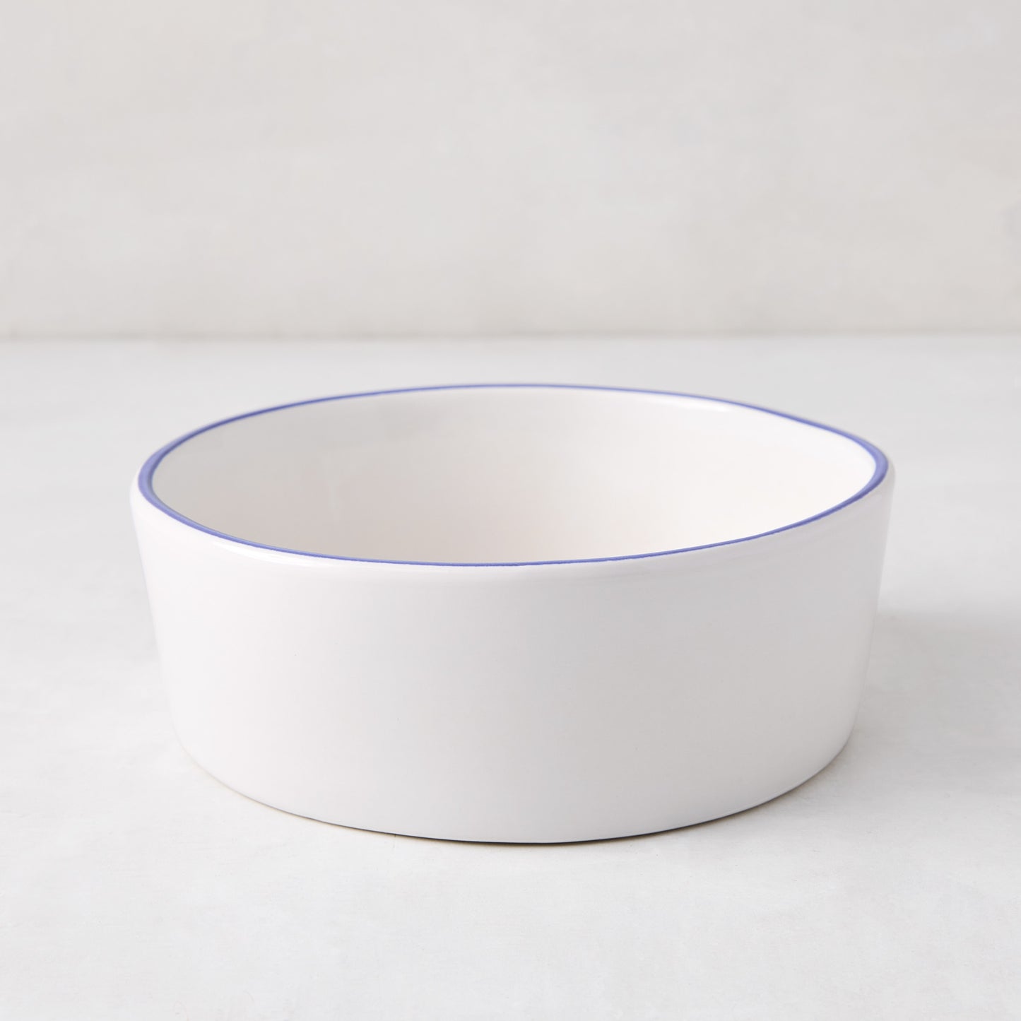 Pacific Blue-Rimmed Stoneware Soup Bowl, 6" diameter, white with hand-painted blue edge, irregular shape.