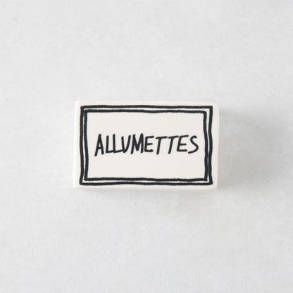 Rectangular white porcelain match box with hand-painted black border and Allumettes text, 3.54 x 2.17 inches.
