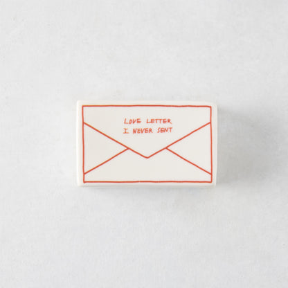 Rectangular white ceramic match box featuring a red hand-drawn envelope design with the text Love Letter I Never Sent.